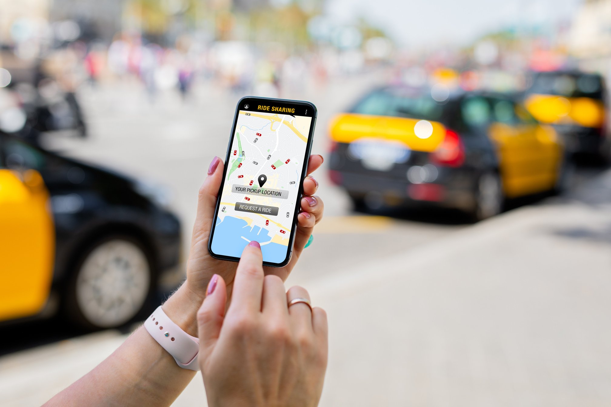 Close-up of Person's Hand Using Ride Sharing App on Phone